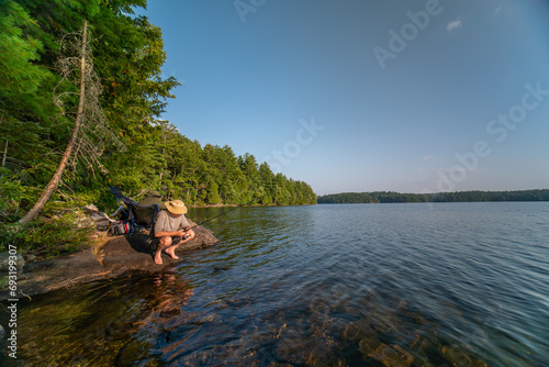 Family hobby, fishing at lake during summer. Throwing fish line reel in the water, fly fishing. Family day vacation at wilderness. Wife and husband alone together have relaxing leisure