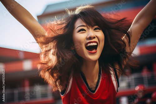 Enthusiastic asian woman in red, surrounded by fans, cheering for victory in a sports competition. Diverse team spirit. Generative ai image