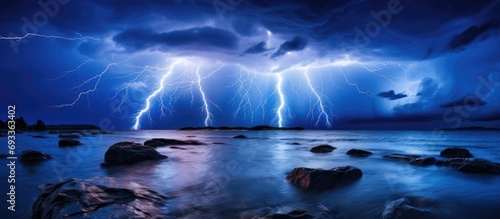 Stunning summer lightning illuminates Atlantic waters at night.