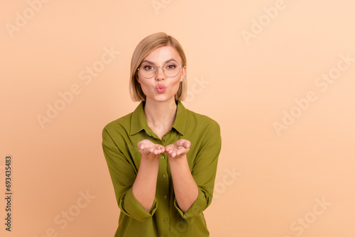 Portrait of flirty coquette girl with straight hairdo wear khaki shirt in eyewear sen air kiss to you isolated on pastel color background
