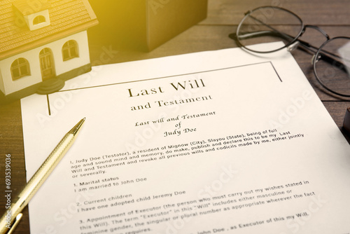 Last Will and Testament, house model, glasses and pen on table, closeup