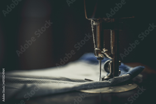 Vintage sewing machine, man sews on a vintage sewing machine, retro sewing machine
