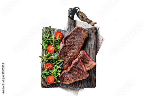 Roasted cap rump or Top sirloin beef meat steak on wooden board with salad. Transparent background. Isolated.