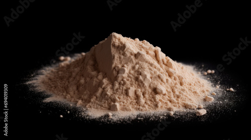 Heap of brown powder depicting heroin isolated on black background