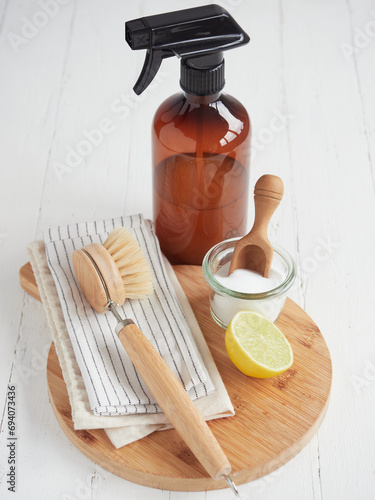 Natural cleaning products. Liquid cleaner in glass spray bottle, lemon and baking soda. Reusable brush and cotton cloths. Environmentally friendly. Zero waste concept. Plastic free.