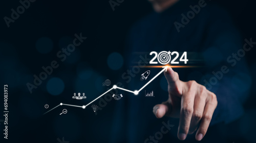 The 2024 new year business goals concept. Businessman touching increase arrow graph company future growth 2024. Business plan target strategy, Planning and challenge business strategy in new year,