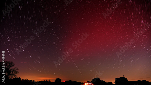 Long exposure of a Stable Auroral Red arc, or SAR arc, a rare space phenomenon over north east Oklahoma sky on November 5th, 2023; with star trails, airplane and satellite tracks crossing the sky