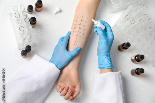 Doctor doing skin allergy test at light table, top view