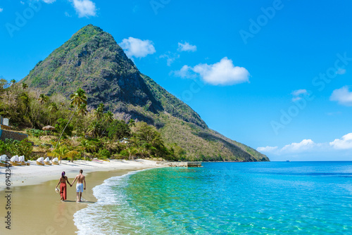 Young couple men and women on vacation in Saint Lucia, luxury holiday Saint Lucia Caribbean, Asian women and Caucasian men on vacation at the tropical Island of Saint Lucia Caribbean