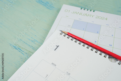 close up of January 2024 calendar on the blue table background, planning for business meeting or travel planning concept