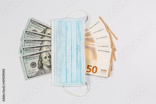 Medical mask and many banknotes of money, medical salary and economy