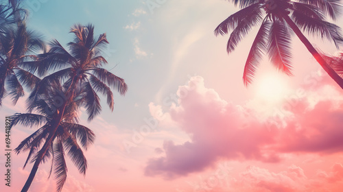 Coconut palm trees on pink sky background. Vintage toned