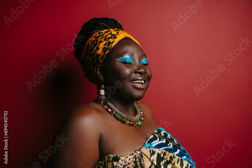 Gorgeous plus size African woman with beautiful make-up wearing traditional headwear 