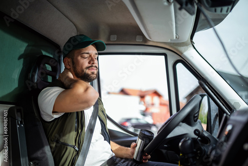 A truck driver's neck hurts from a long drive