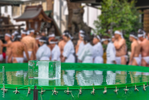 A plastic pool filled with cold water containing a huge block of ice used by worshipers at Tokyo's Teppozu Shrine to bathe and purify themselves during the Kanchu-suiyoku-taikai in January.