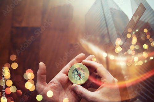 Double exposure businessman with vintage compass in a hand and skyscraper. concept to make decision or choose direction