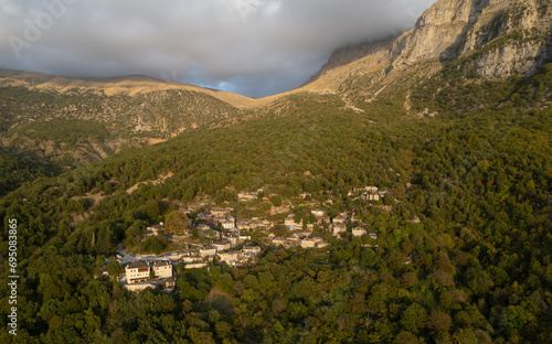 Drone scenery mikro Papingo village , Zagorochoria area, Epirus, Ioannina Greece. Astraka tower rocky cliffs above the village at sunset