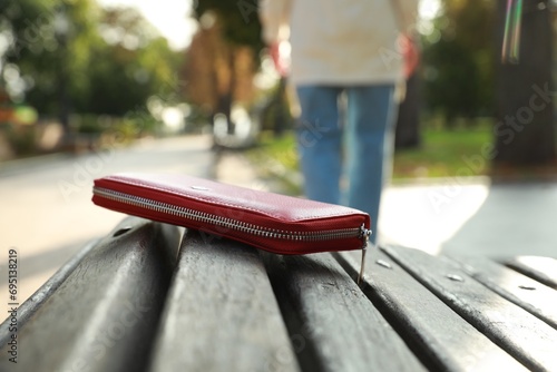 Woman lost her purse on wooden surface outdoors, selective focus. Space for text