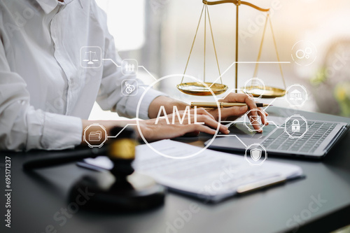 AML Anti Money Laundering Financial Bank Business Concept. judge in a courtroom using laptop and tablet with AML anti money laundering icon on virtual .
