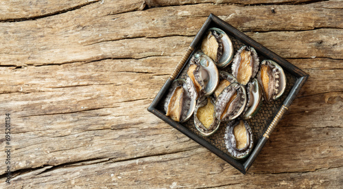 Fresh abalone on wooden plate