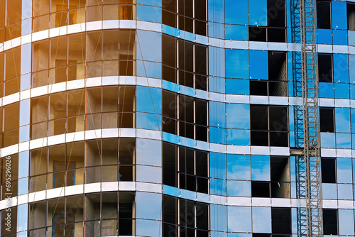 Glass curtain wall installation. Install of double-glazed windows in multi-storey building at construction site. Facade glazing, glazed façade.