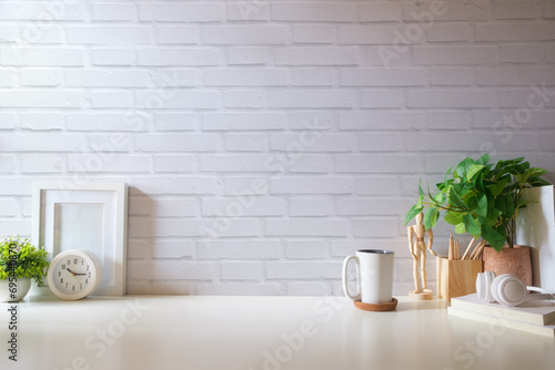 Comfortable workplace with coffee, stationery and houseplant on white table. Home office, copy space.