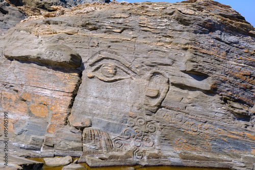 God Aeolus carved on the rock at Kavalourko Beach