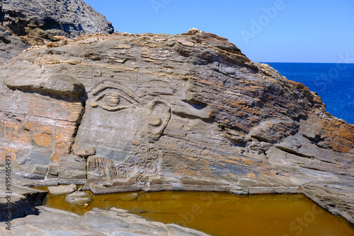 God Aeolus carved on the rock at Kavalourko Beach