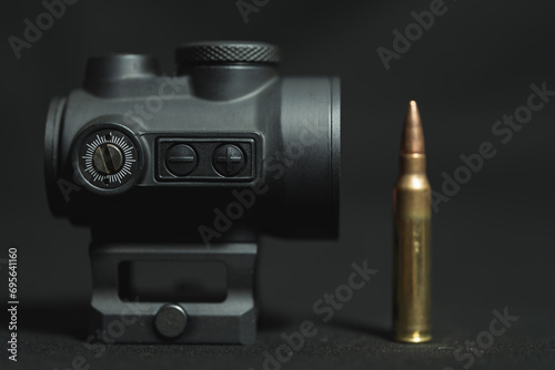 Red dot sight for firearms, close-up photo.