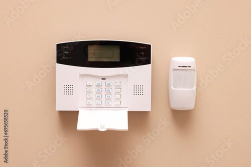 Home security alarm system on beige wall
