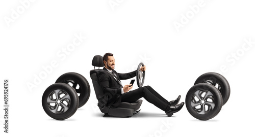 Businessman using a mobile phone and driving