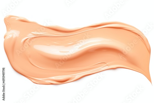 Tone bb cream smear swatch isolated on white background. Trendy peach fuzz color.