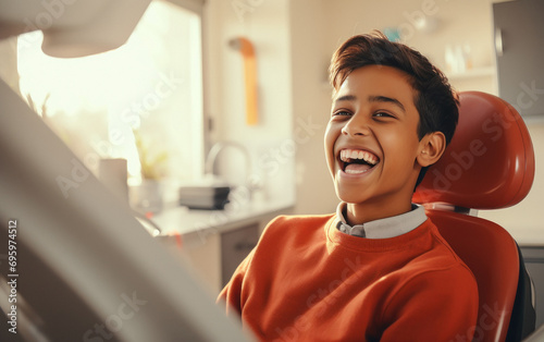indian boy laying on the dental chair and laughing