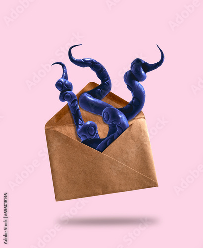 Purple octopus tentacles stick out of vintage envelope. Humor postcard about mail services.