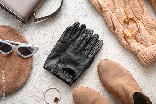 Composition with female leather gloves, shoes and accessories on light background