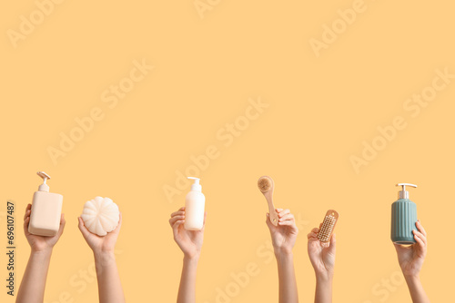 Female hands with bath supplies on color background
