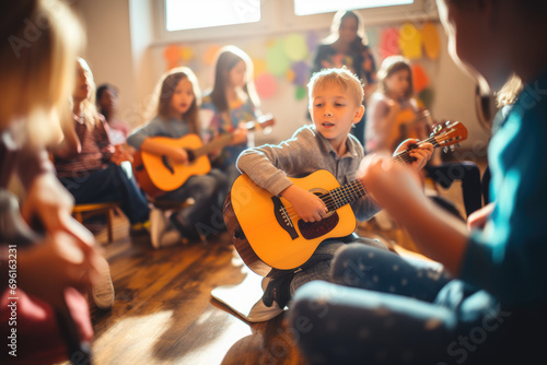 young children playing guitar in classroom