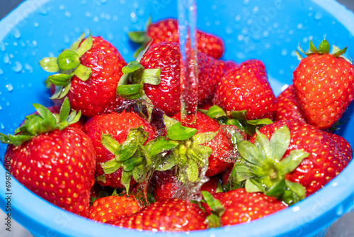 Strawberries in a colander while washing