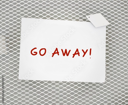 Stick note with text written GO AWAY! - to tell other to leave me alone, stop disturbing, interfering or to stop bothering with unpleasant feeling