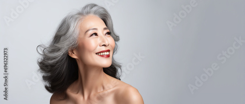 Korean woman face with smooth healthy neckline skin. Korean, Chinese asian Beautiful aging years old, young looking smiling woman, beauty health skincare and cosmetics advertising concept