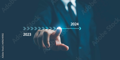 2024,Businessman touch on virtual bar status to change from 2023 to 2024, countdown of merry Christmas and happy new year by technology concept, start up on new years. start new business and new life