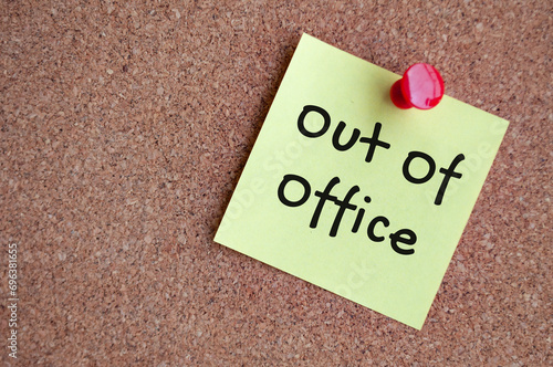 Out of office text on sticky note. Out of office concept