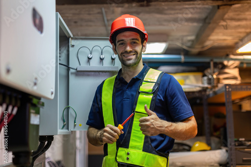 Electrical engineer working in control room. Electrical engineer man checking Power Distribution Cabinet in the control room