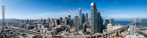 San Francisco, USA, panoramic aerial landscape view of Skyscraper Skyline of "South of Market" (SoMA) district with famous Salesforce Tower, other new modern buildings and Bay Bridge - aerial city