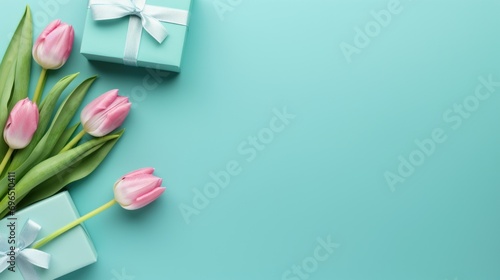 A bouquet of pink tulips next to a gift box. Spring greeting for birthday, Easter or Mother's day.