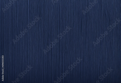 Deep Navy Corduroy Fabric Texture. Sophisticated Background for Creative Space. Natural Ribbed Cotton Material. Robust Textile Detail. Close-Up View.