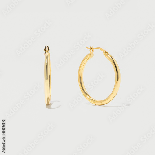 Product photo of gold hoop earrings on grey background