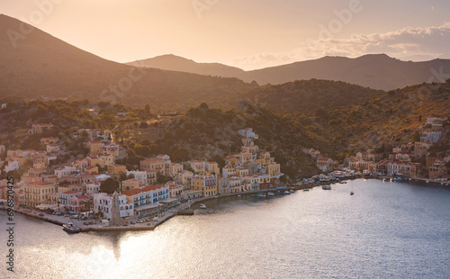 Symi Island, Greece. Greece islands holidays from Rhodos in Aegean Sea. Colorful neoclassical houses in bay of Symi. view of main bay of island, where tourist ferries and yachts moor