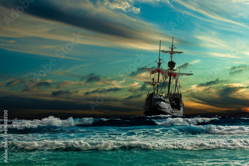 Grand view of an old sailing ship from the times of pirates and the Middle Ages on the high seas with big waves and with a beautiful sky