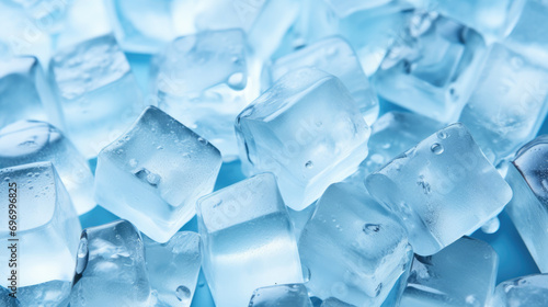 Top view of a pile of frosty frozen ice cubes on a blue background, refreshing, cold, ready for adding to a cold drink in a celebration or party or adding to a frozen fruit smoothie or blended dessert